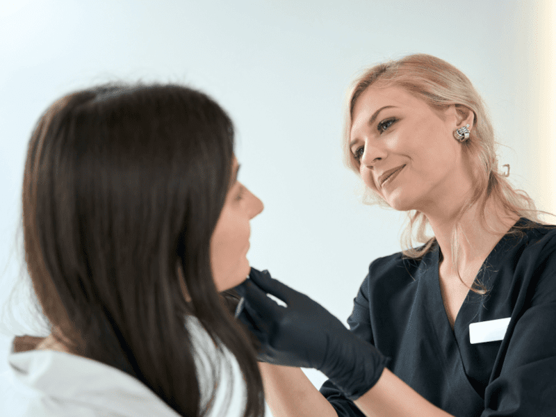 Dermatologist examining patient's skin